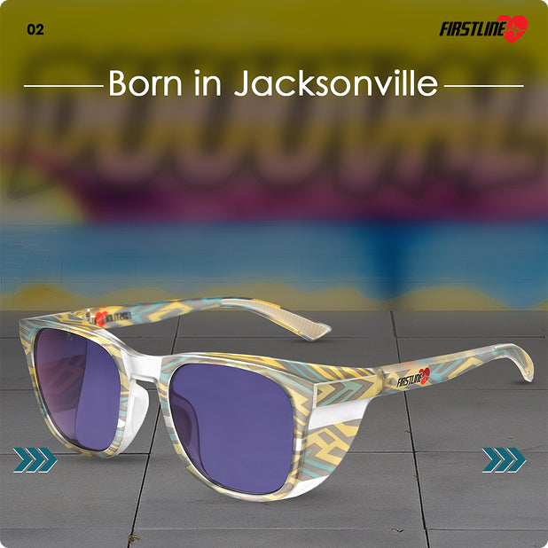 Safety googles with photochromic lenses and colorful frame on a gray surface with 'Duuuval' mural in the background.